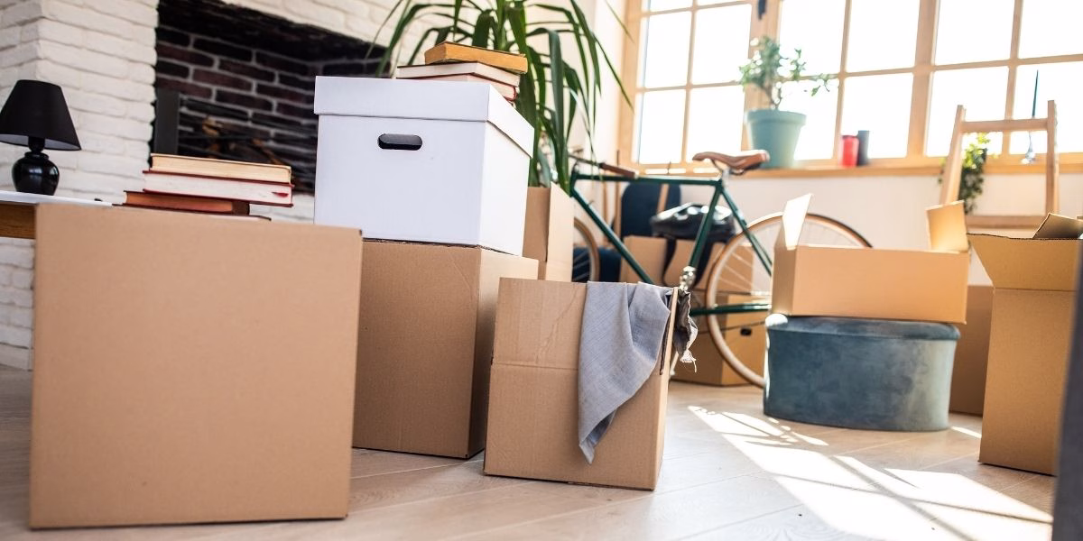 Half-packed boxes on the floor of an apartment