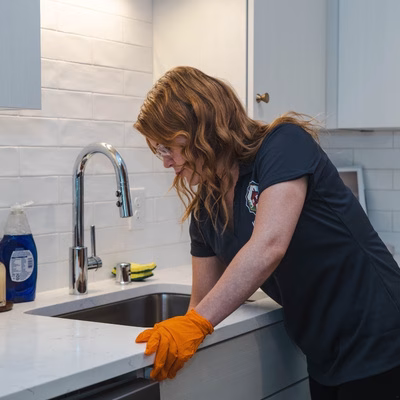 Minneapolis house cleaner wiping down a kitchen sink