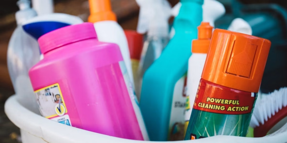Essential cleaning products and tools in a bucket