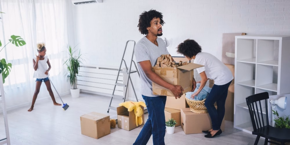 A mother, father, and daughter unpacking boxes after moving into a new home near Minneapolis, MN