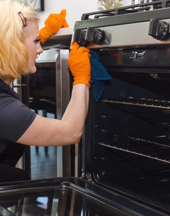 Claire Hensley deep cleaning a kitchen oven